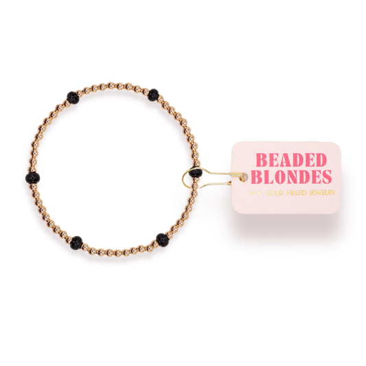Beaded bracelet with black beads on a white background, featuring the brand 'Beaded Blondes'.