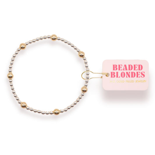 Beaded hair tie with 'Beaded Blondes' packaging on a white background
