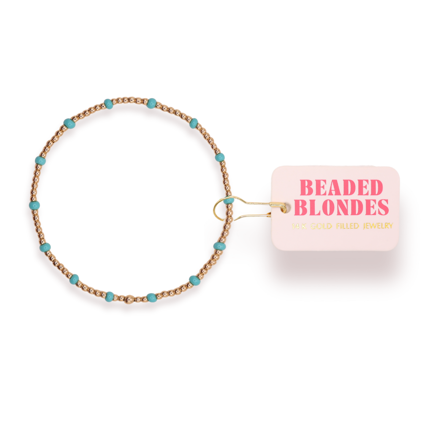 Beaded hair tie with turquoise beads and a pink card labeled 'Beaded Blondes' on a white background