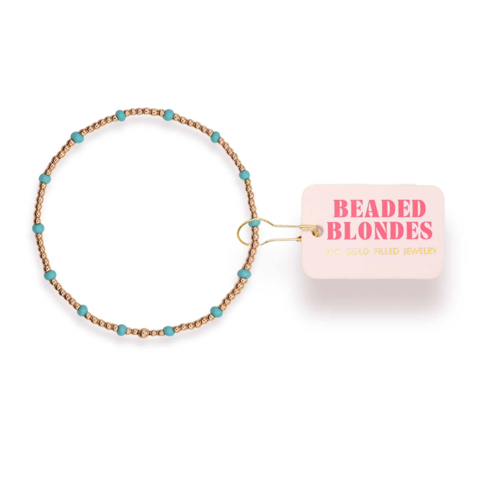 Beaded hair tie with turquoise beads and a pink card labeled 'Beaded Blondes' on a white background
