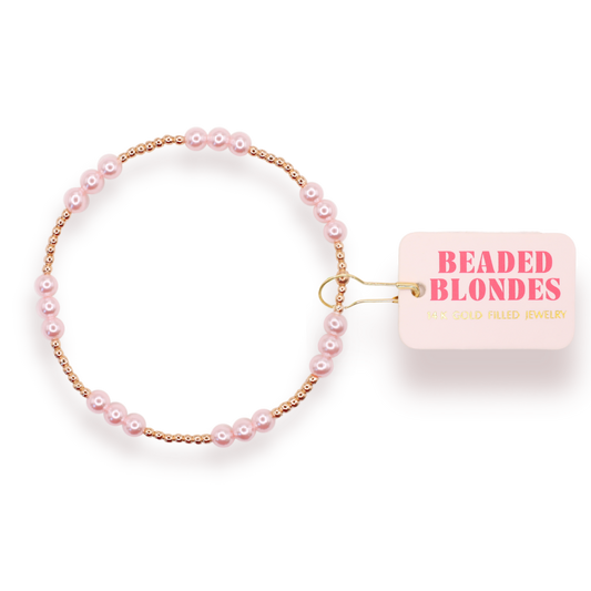 Beaded bracelet with pink pearls and gold accents on a clear background, featuring 'Beaded Blondes' brand tag.