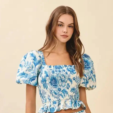 Woman wearing a blue floral blouse on a beige background