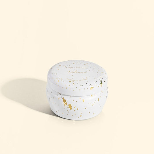 Round white container with gold speckles on a beige background