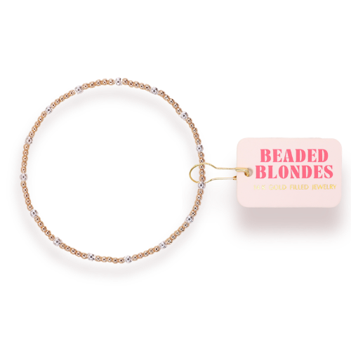 Gold beaded bracelet with a 'Beaded Blondes' tag on a white background