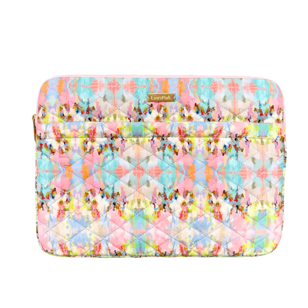 Colorful quilted laptop sleeve with a pattern on a white background
