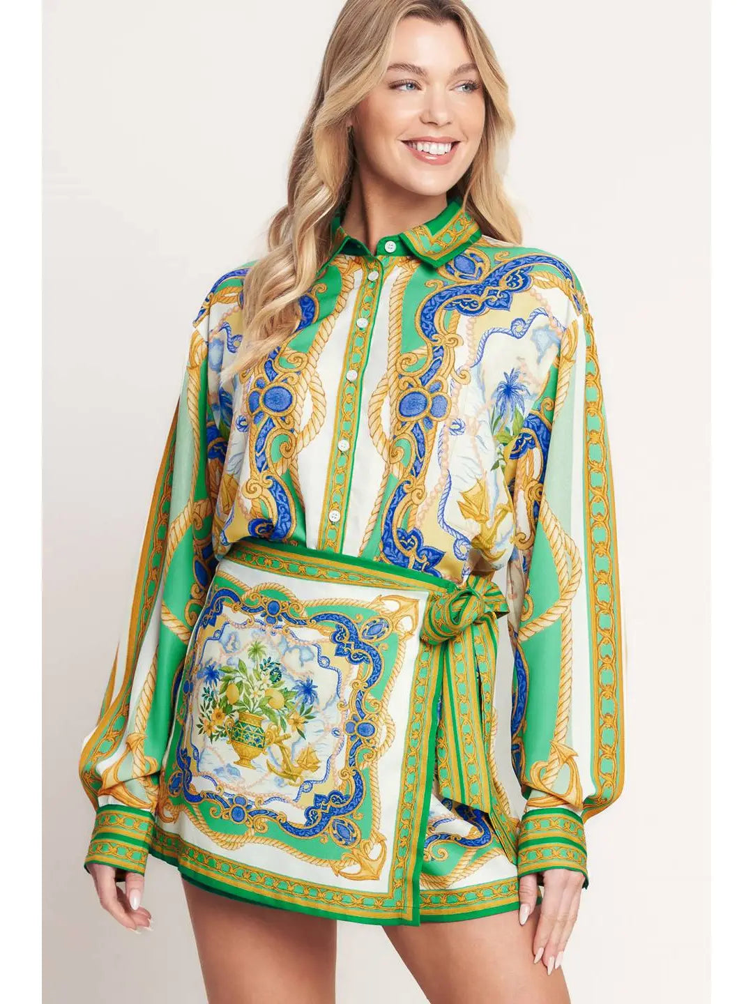 Woman wearing a patterned dress with a belt on a plain background