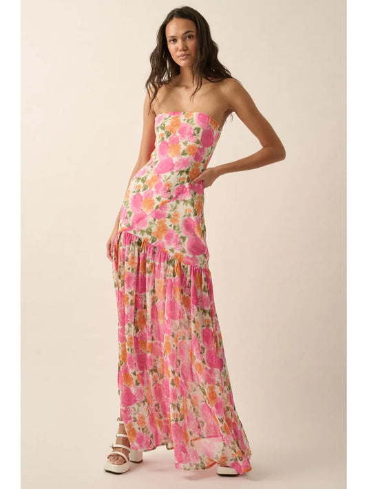 Woman wearing a strapless floral dress on a plain background