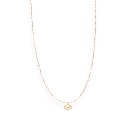 Gold necklace with a small pendant on a white background