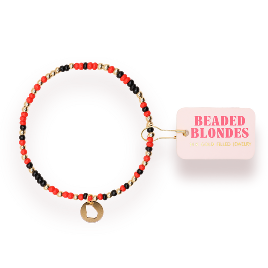 Beaded bracelet with red, black, and gold beads on a white background with 'Beaded Blondes' packaging.