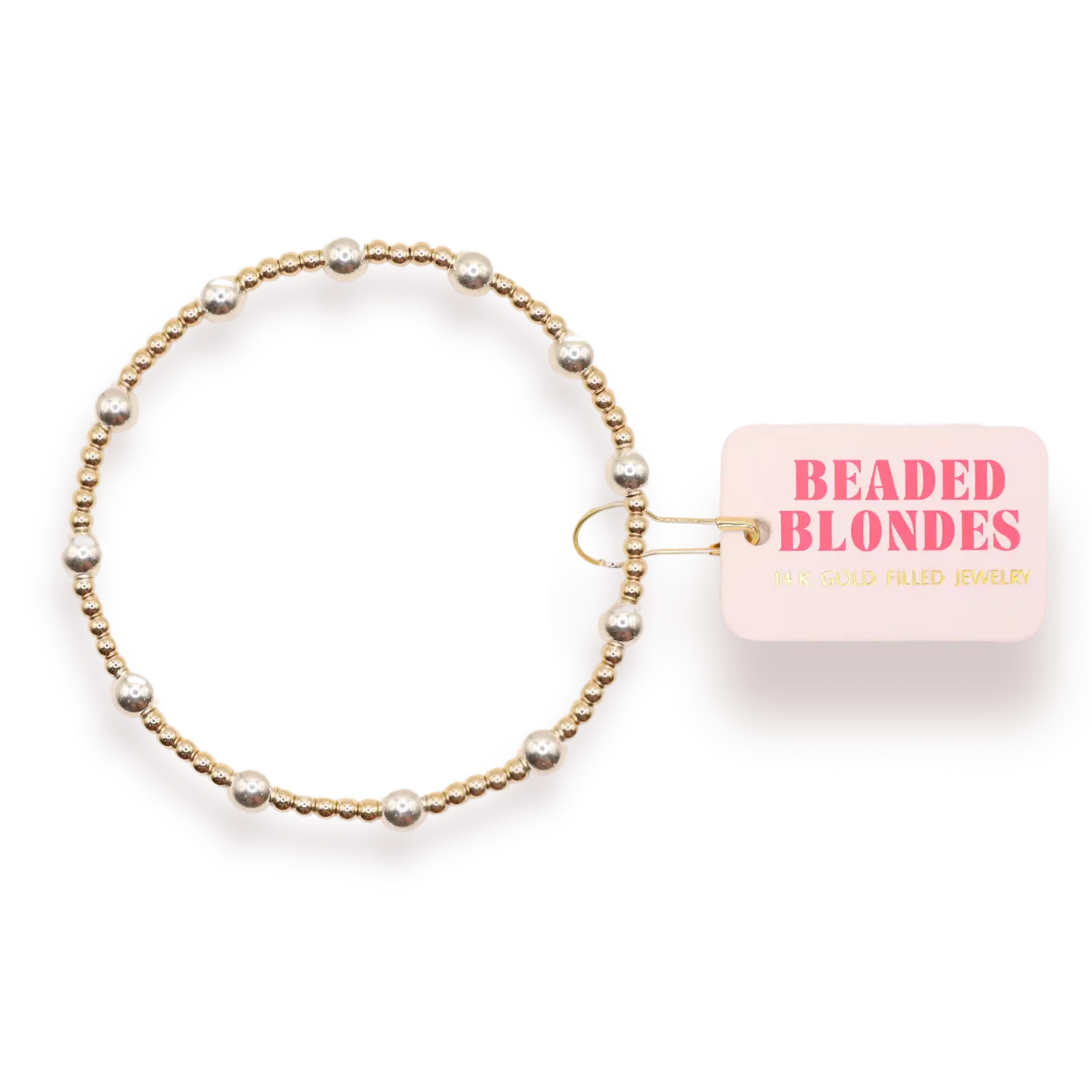 A gold beaded stretch bracelet with silver-toned pearl-like beads, shown next to a pink tag that reads 'BEADED BLONDES'.