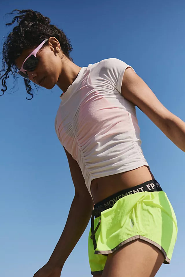 Woman in athletic wear with a clear blue sky background