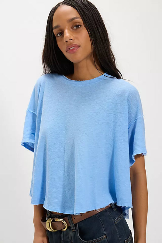 Woman wearing a light blue t-shirt against a white background