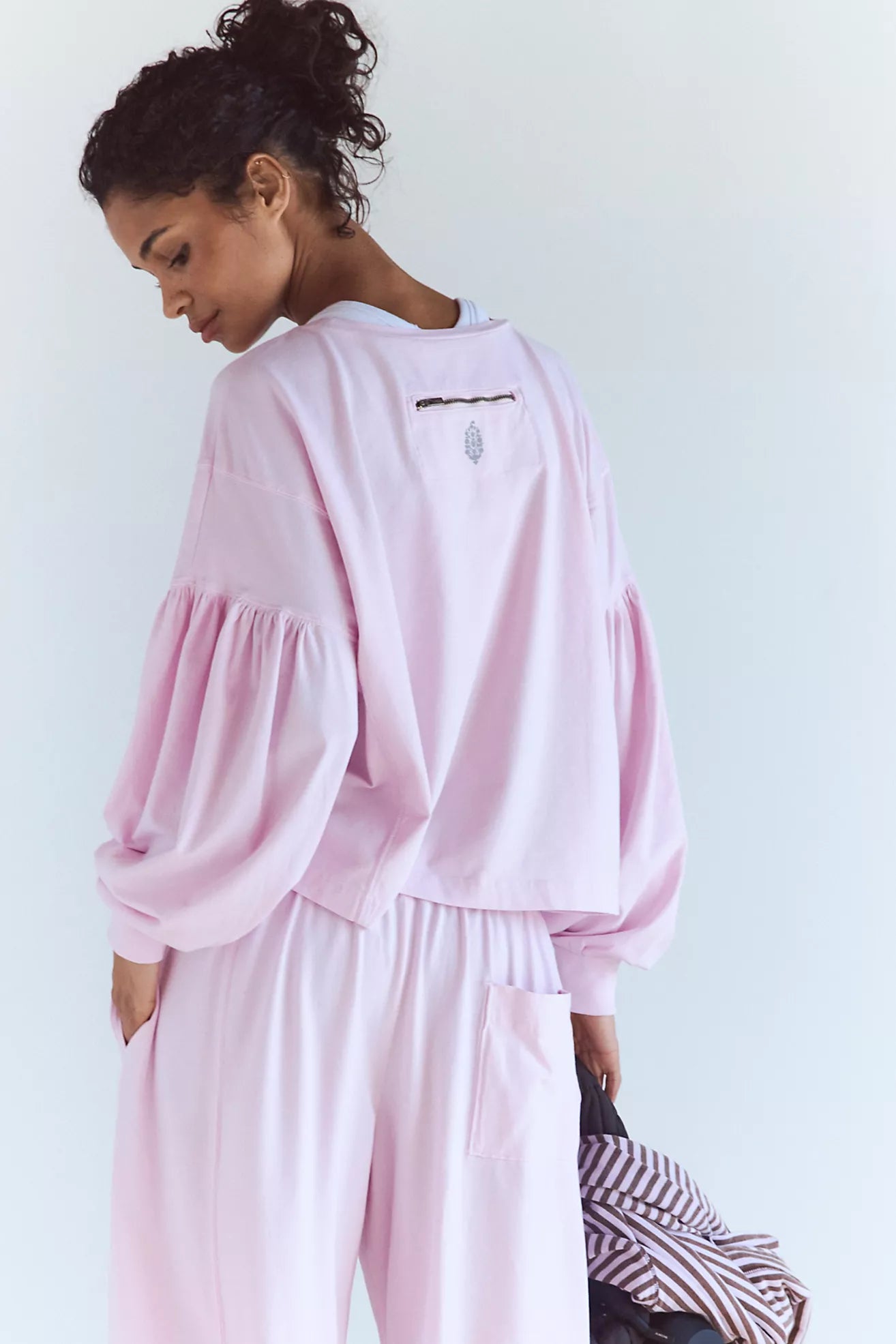 Person wearing a pink outfit with a white background