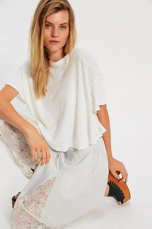 Woman holding a white handbag with a plain background