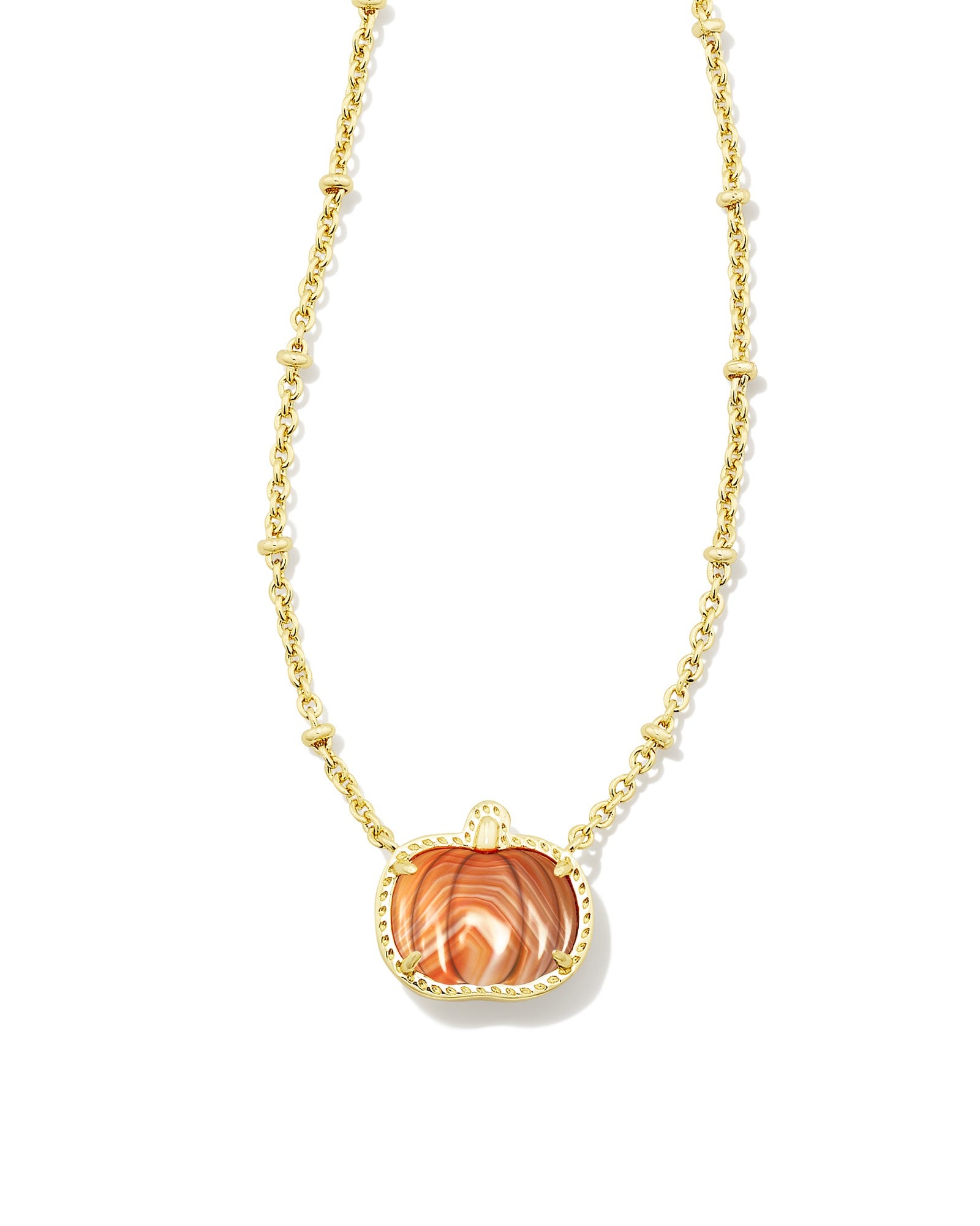 Gold necklace with orange pumpkin pendant on white background