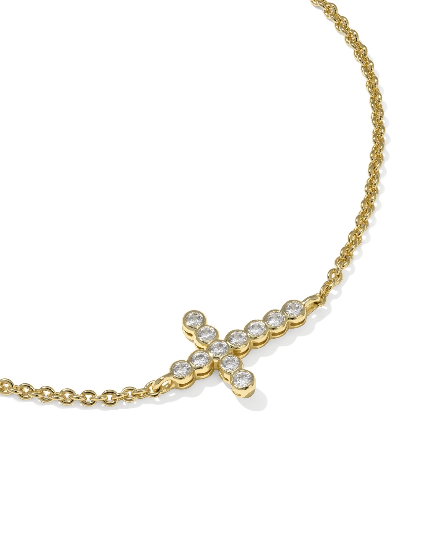 KENDRA SCOTT Gold Cross Crystal Delicate Chain Bracelet on white background close up