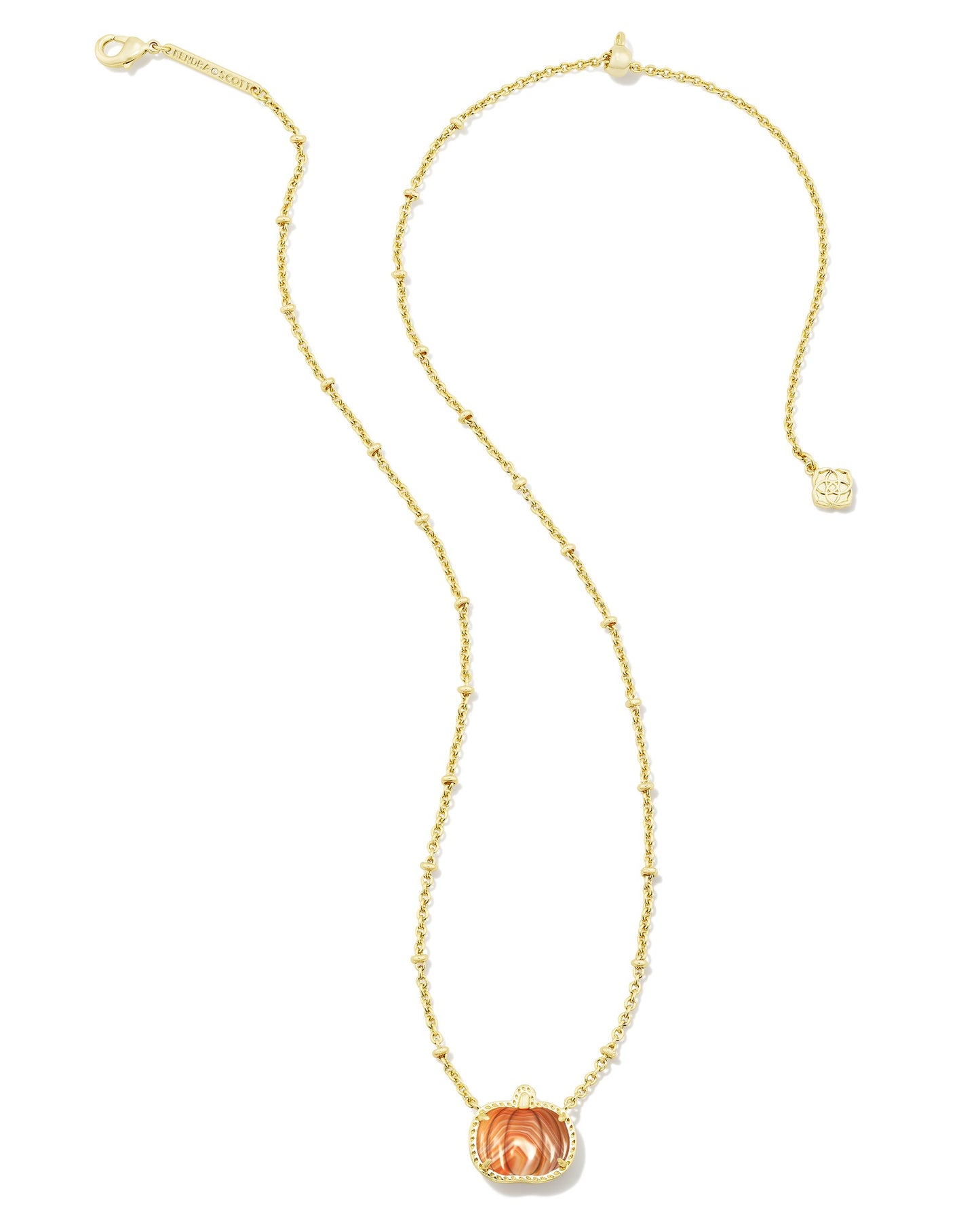 Gold necklace with orange pumpkin pendant on white background including clasps 