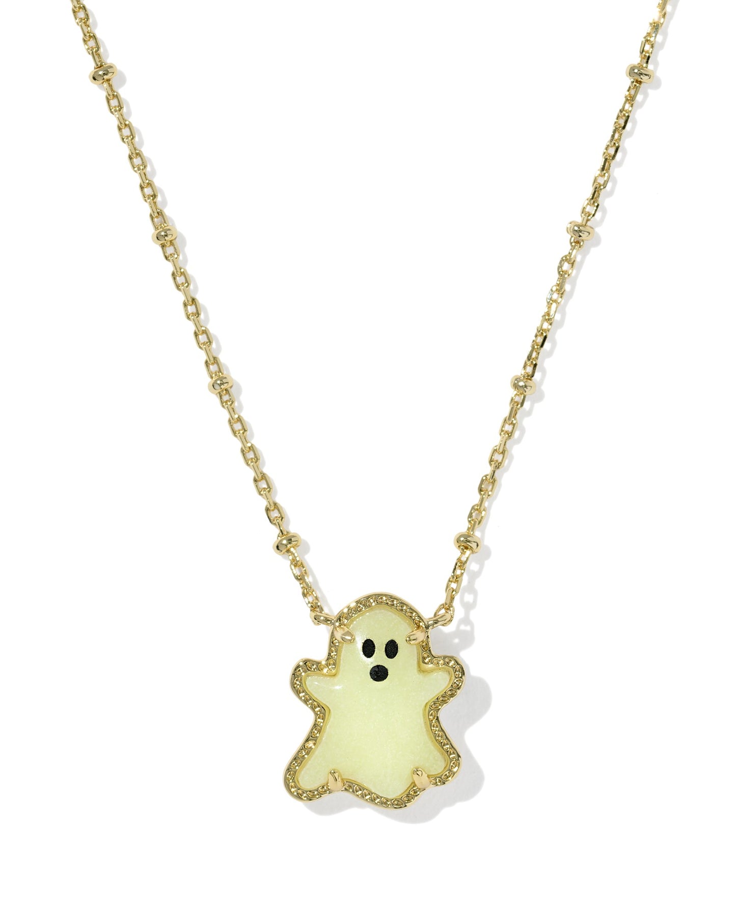 Gold necklace with glow in the dark ghost pendant on white background
