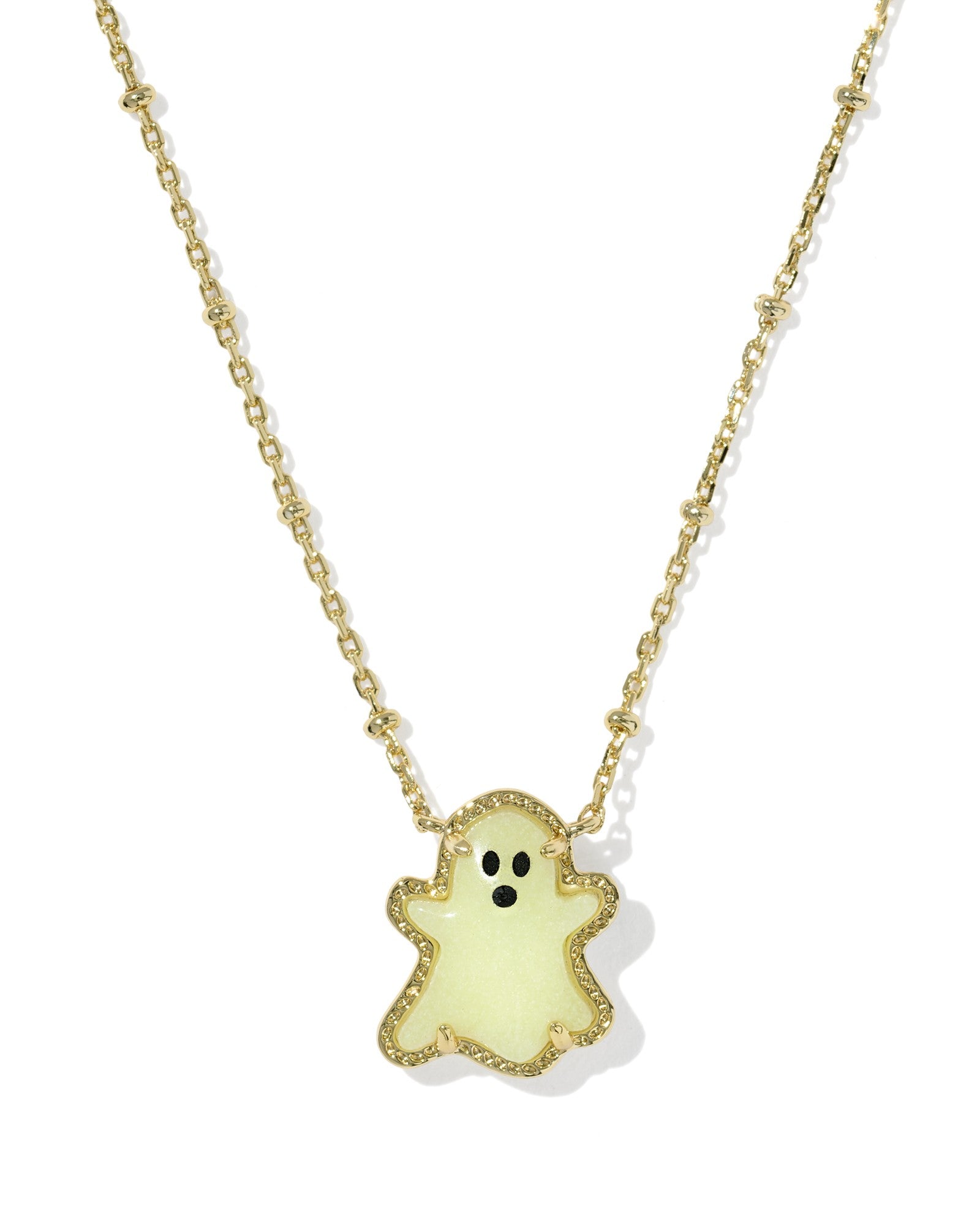 Gold necklace with glow in the dark ghost pendant on white background