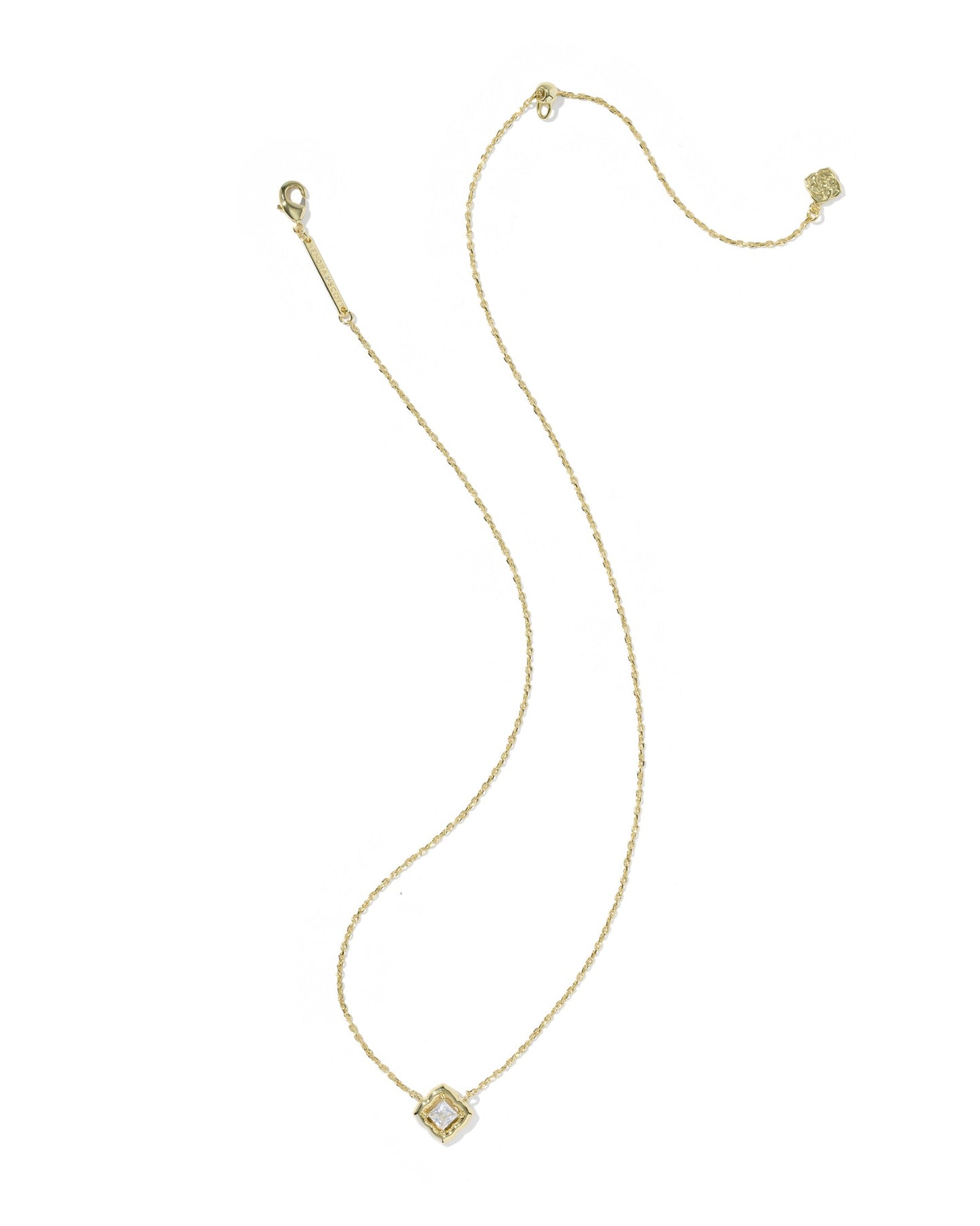 gold necklace with crystal pendant on white background