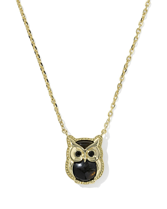 Gold owl-shaped pendant necklace on a white background