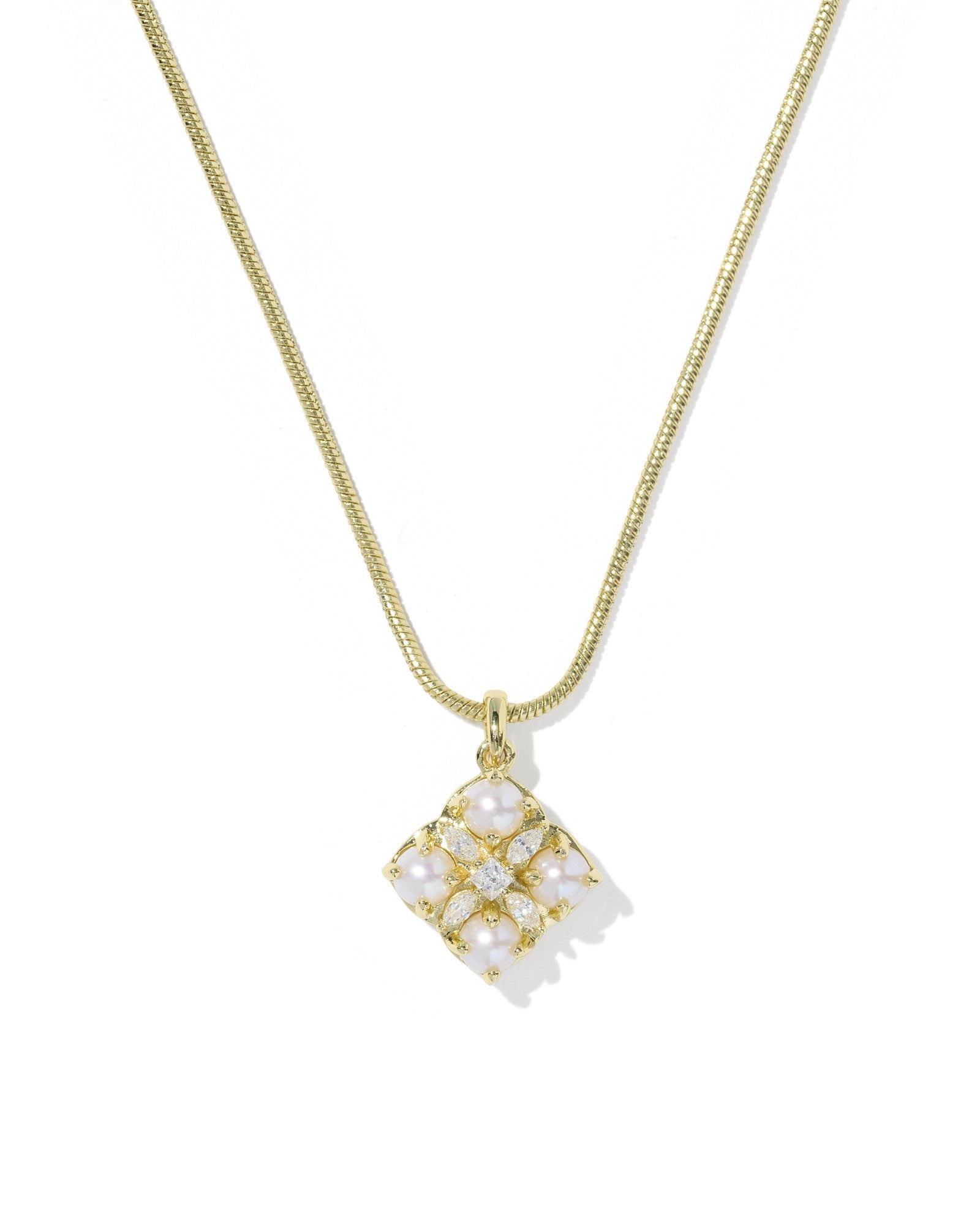 Gold necklace with a square pendant on a white background
