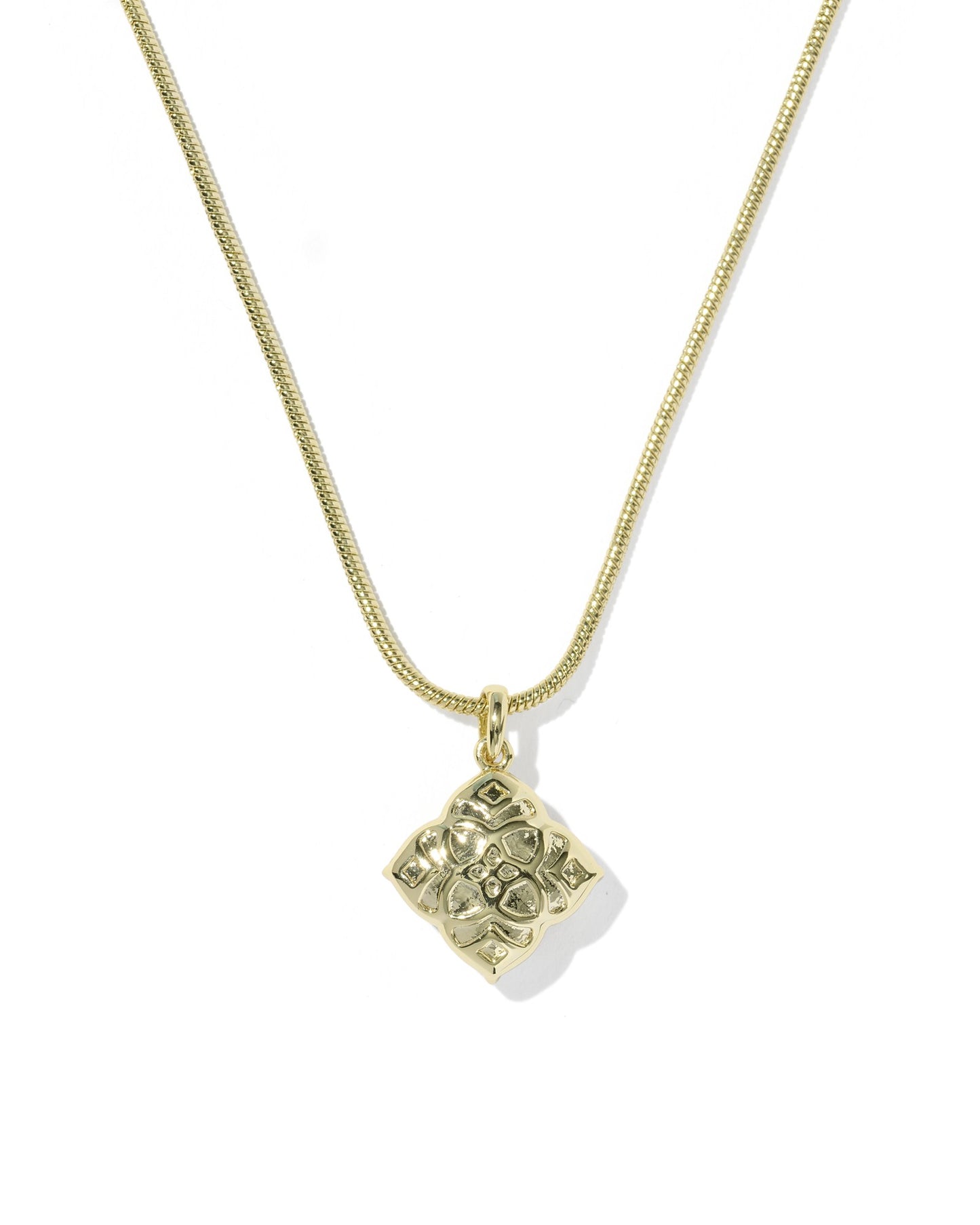 Gold necklace with a square pendant on a white background