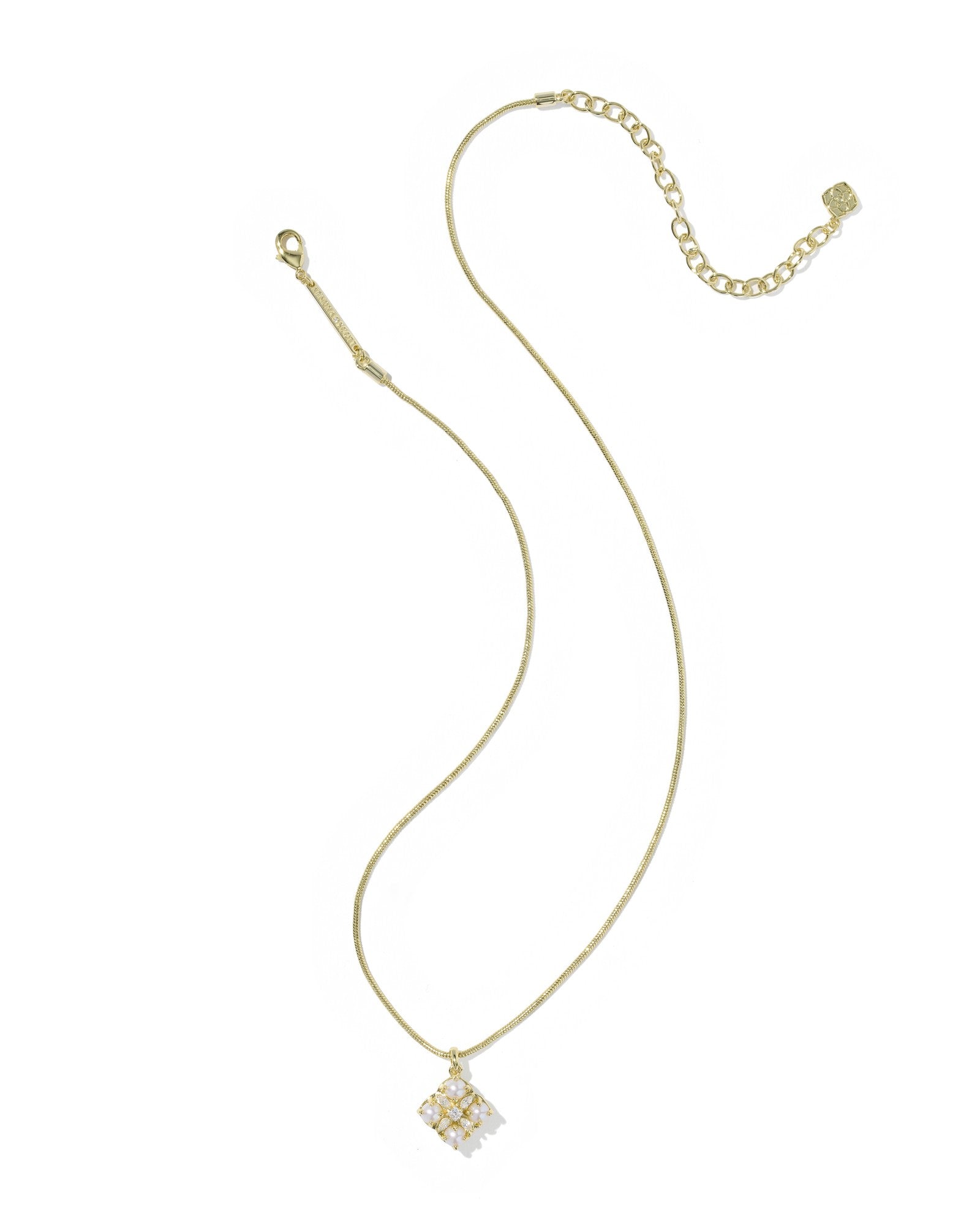 Gold necklace with a small pendant on a white background
