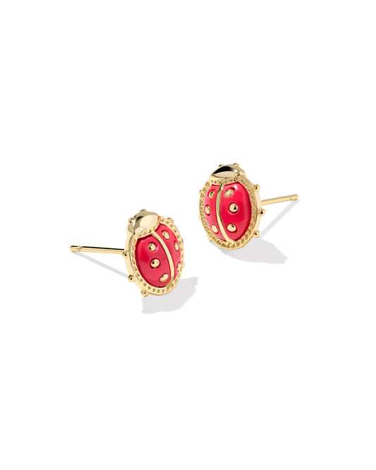 Gold earrings with red stones on a white background