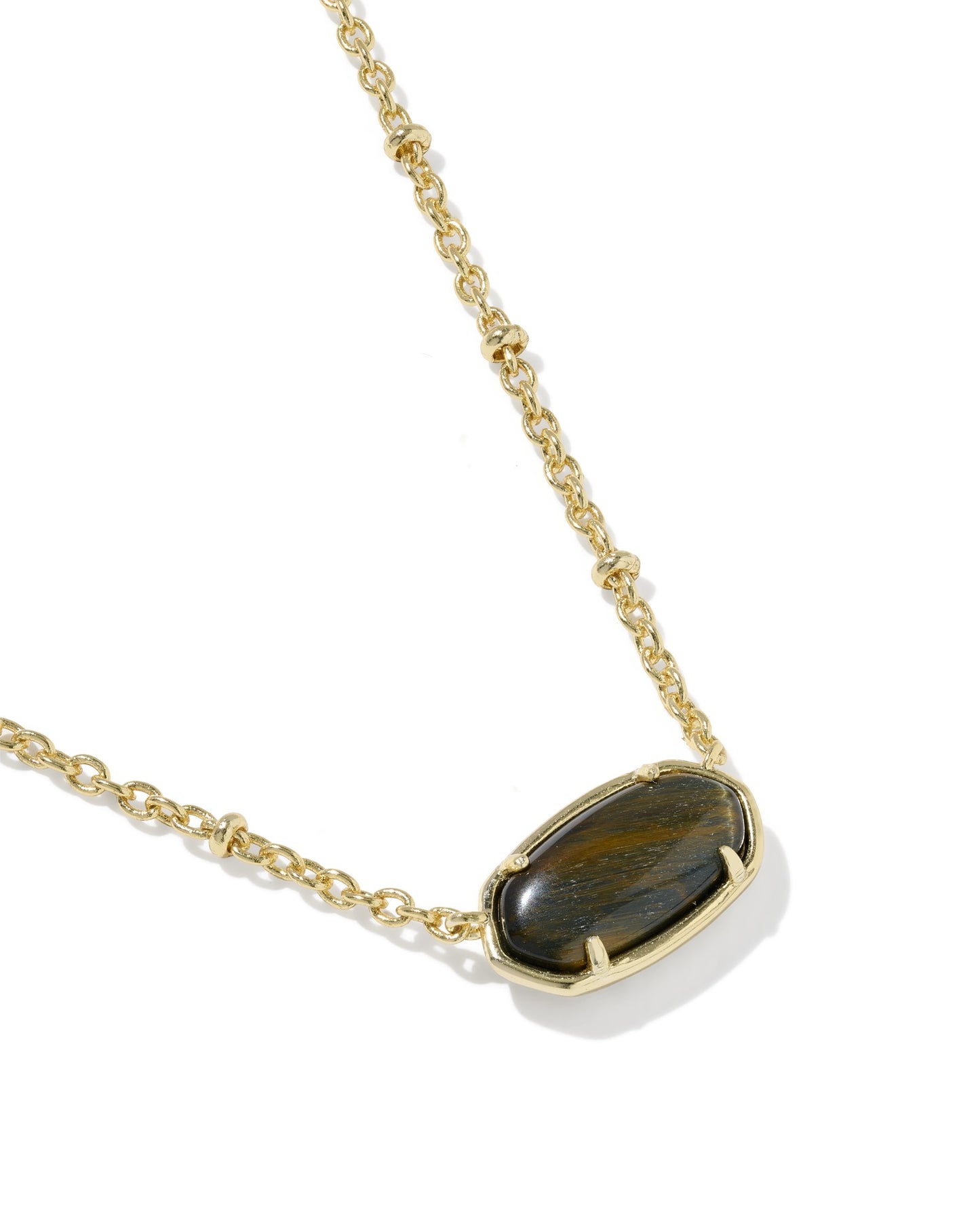 Gold necklace with a tiger's eye stone pendant on a white background