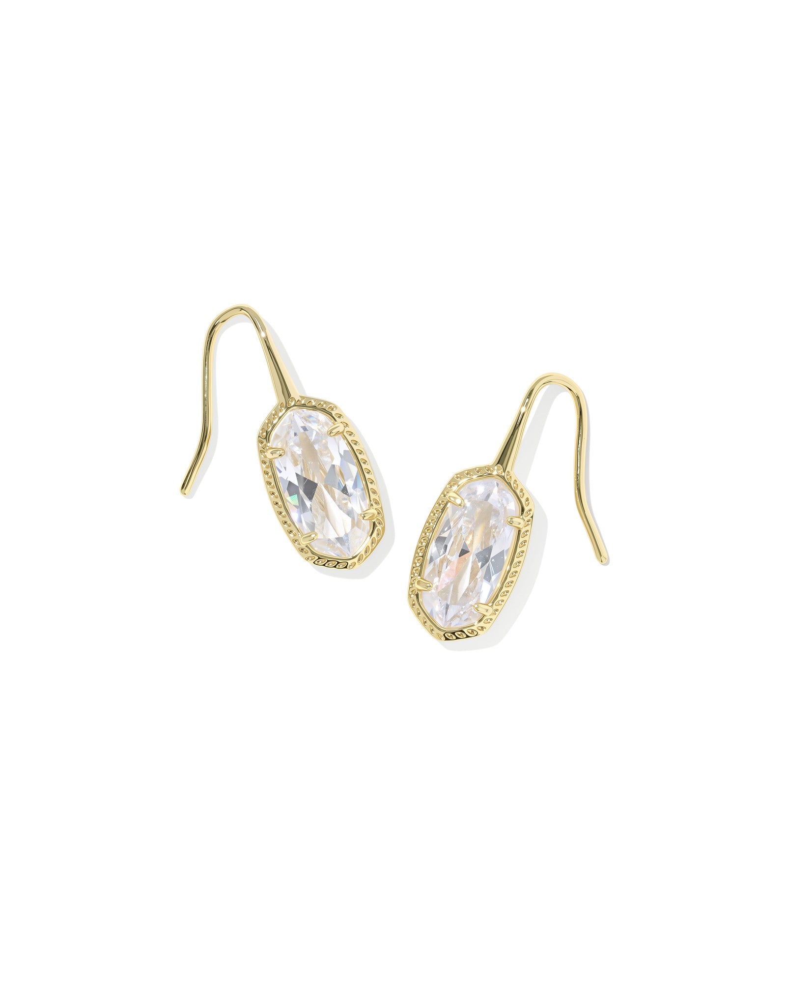 Kendra scott gold drop earrings with clear pendant on white background 