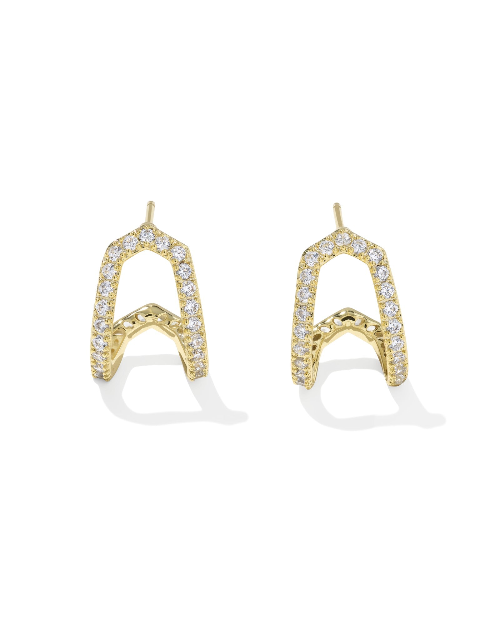Gold earrings with diamond accents on a white background
