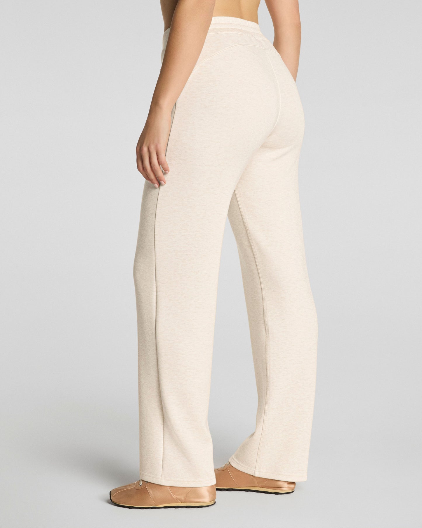 Beige pants worn by a person on a plain background