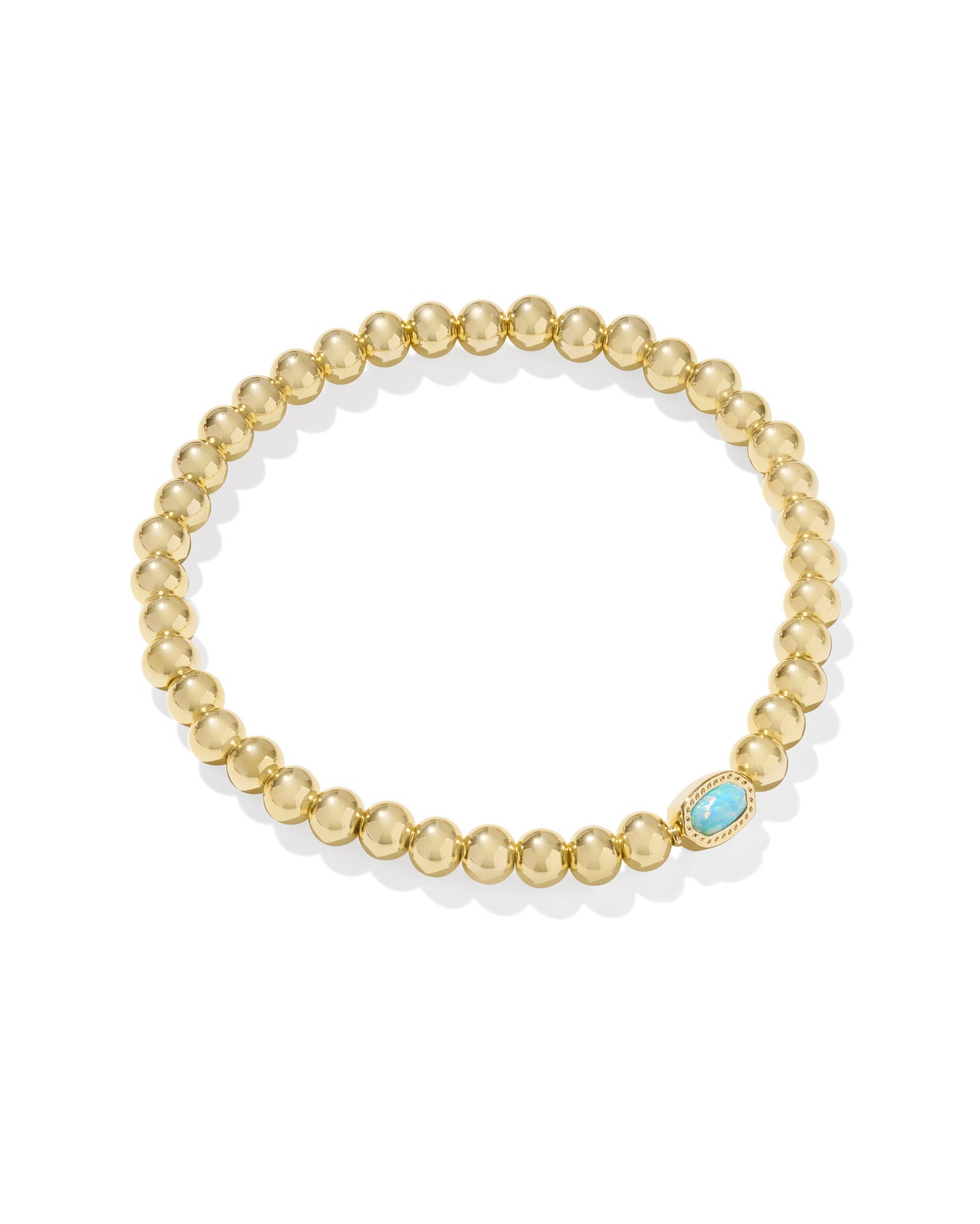Gold beaded bracelet with a blue gemstone on a white background