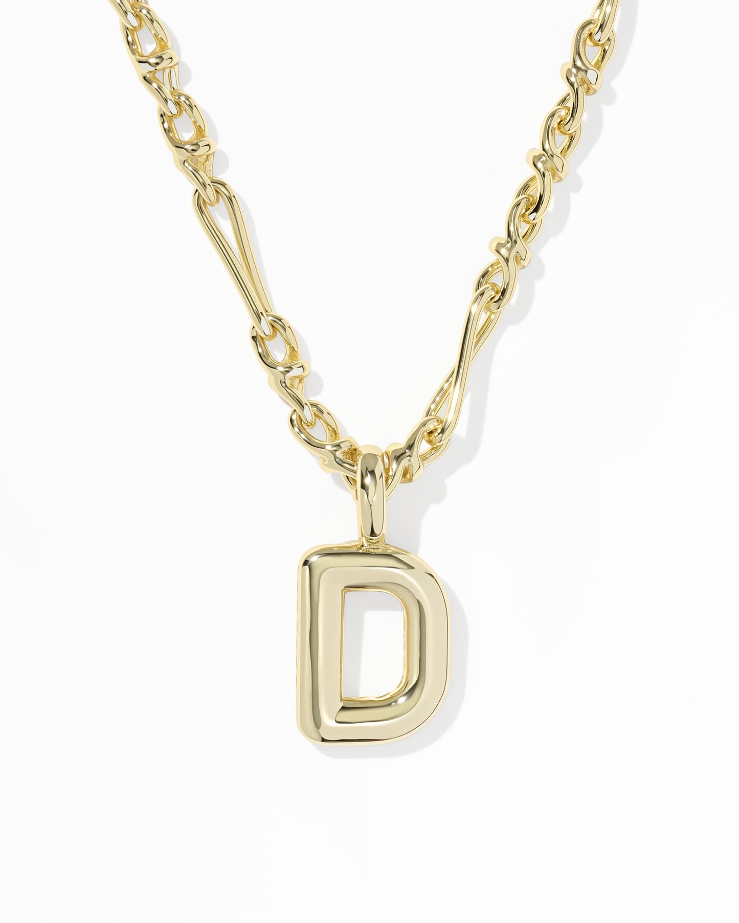 Gold necklace with a 'D' pendant on a white background