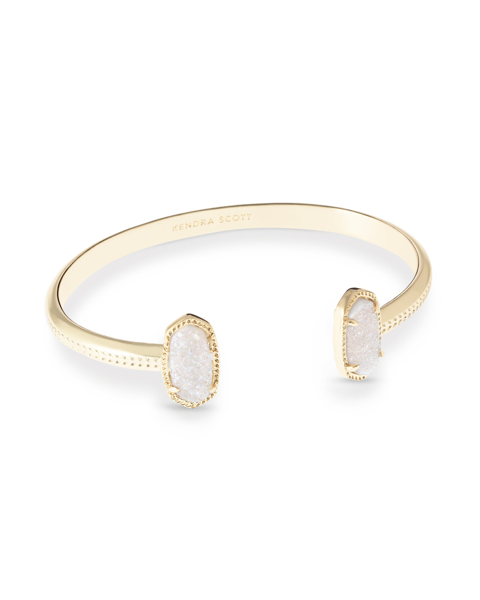 Gold bracelet with white stone on a white background