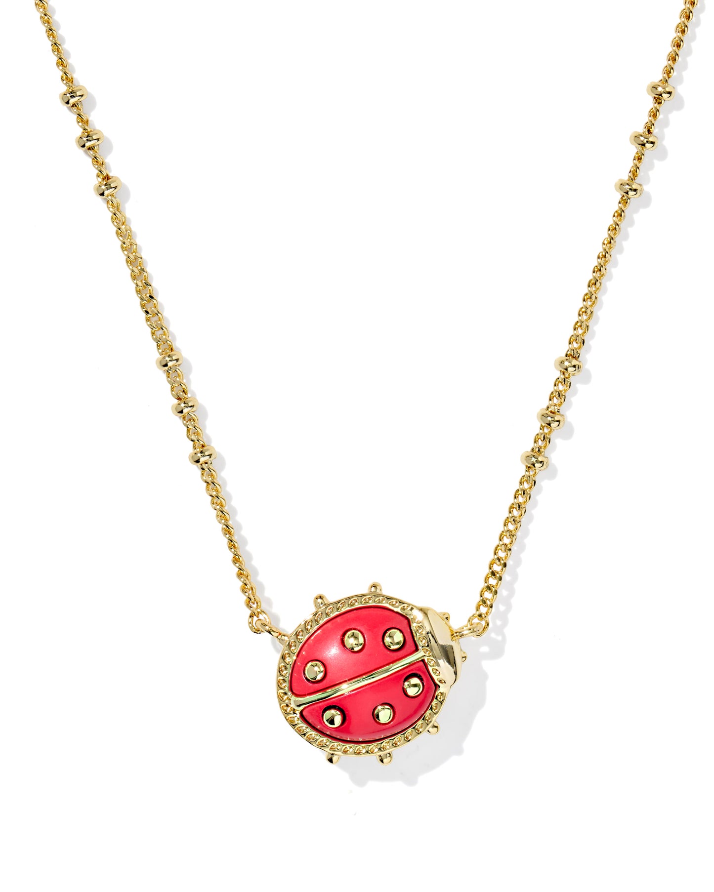 Gold necklace with a red ladybug pendant on a white background