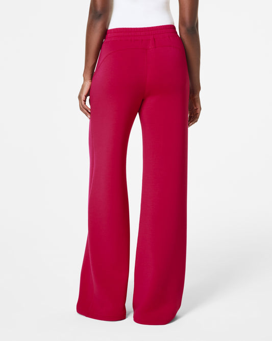 Model standing facing backwards with pink spanx pants 
