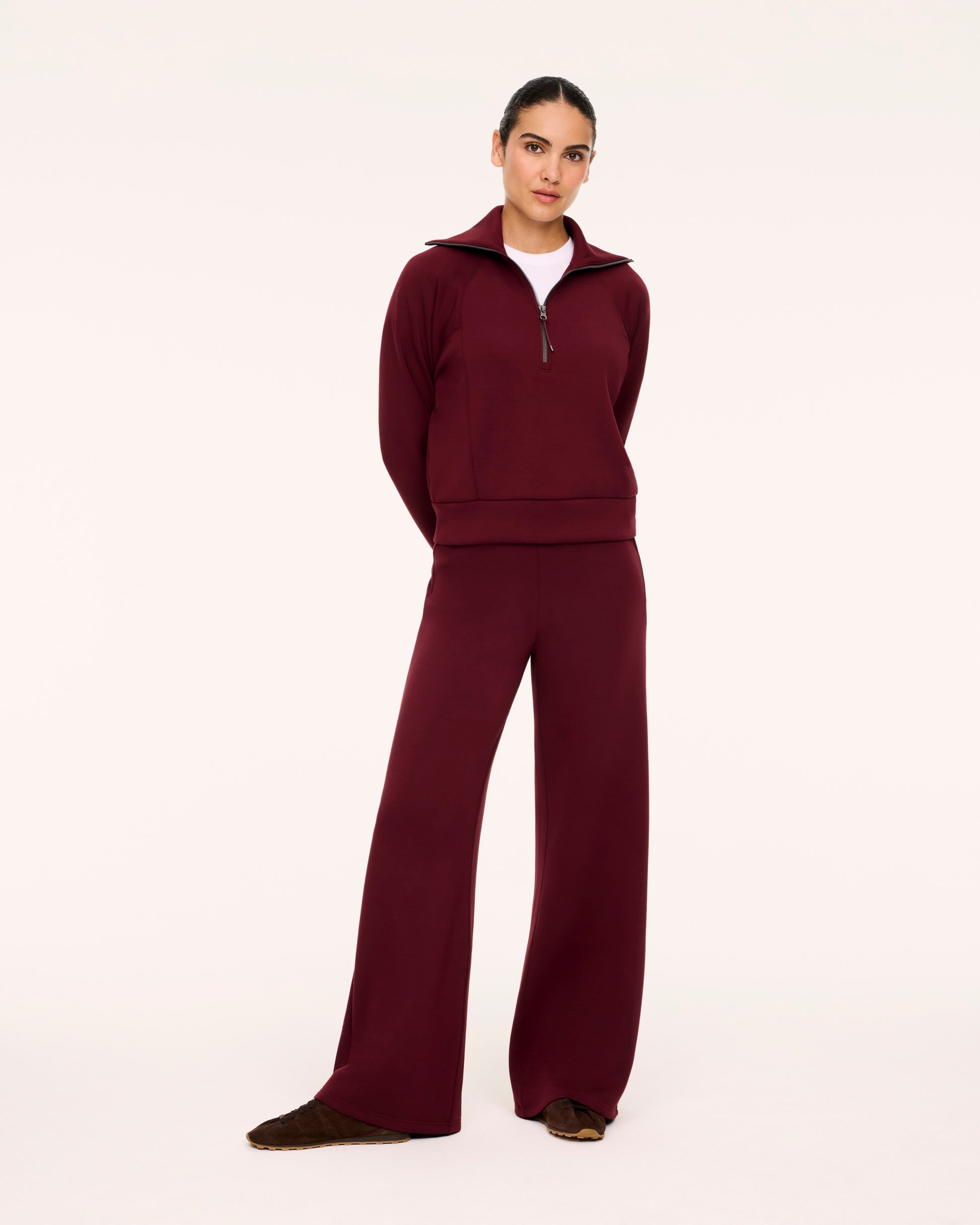 Woman in Spanx Vino Half-Zip Set with white background.