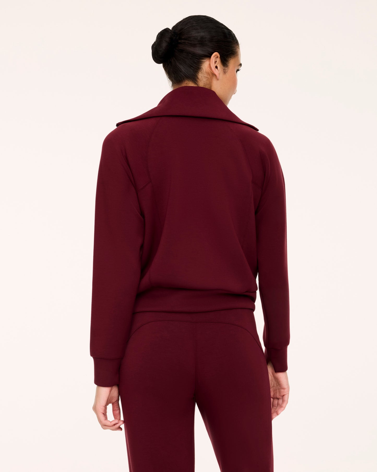 Back of woman in Spanx Vino Half-Zip Set with white background