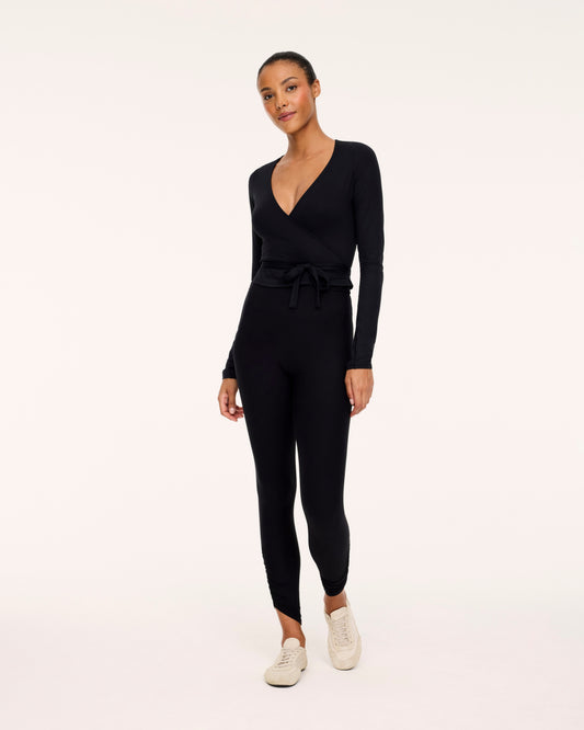Woman wearing Spanx Ballet Wrap Top in Black with white background