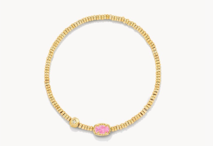 Gold bracelet with a pink gemstone on a white background
