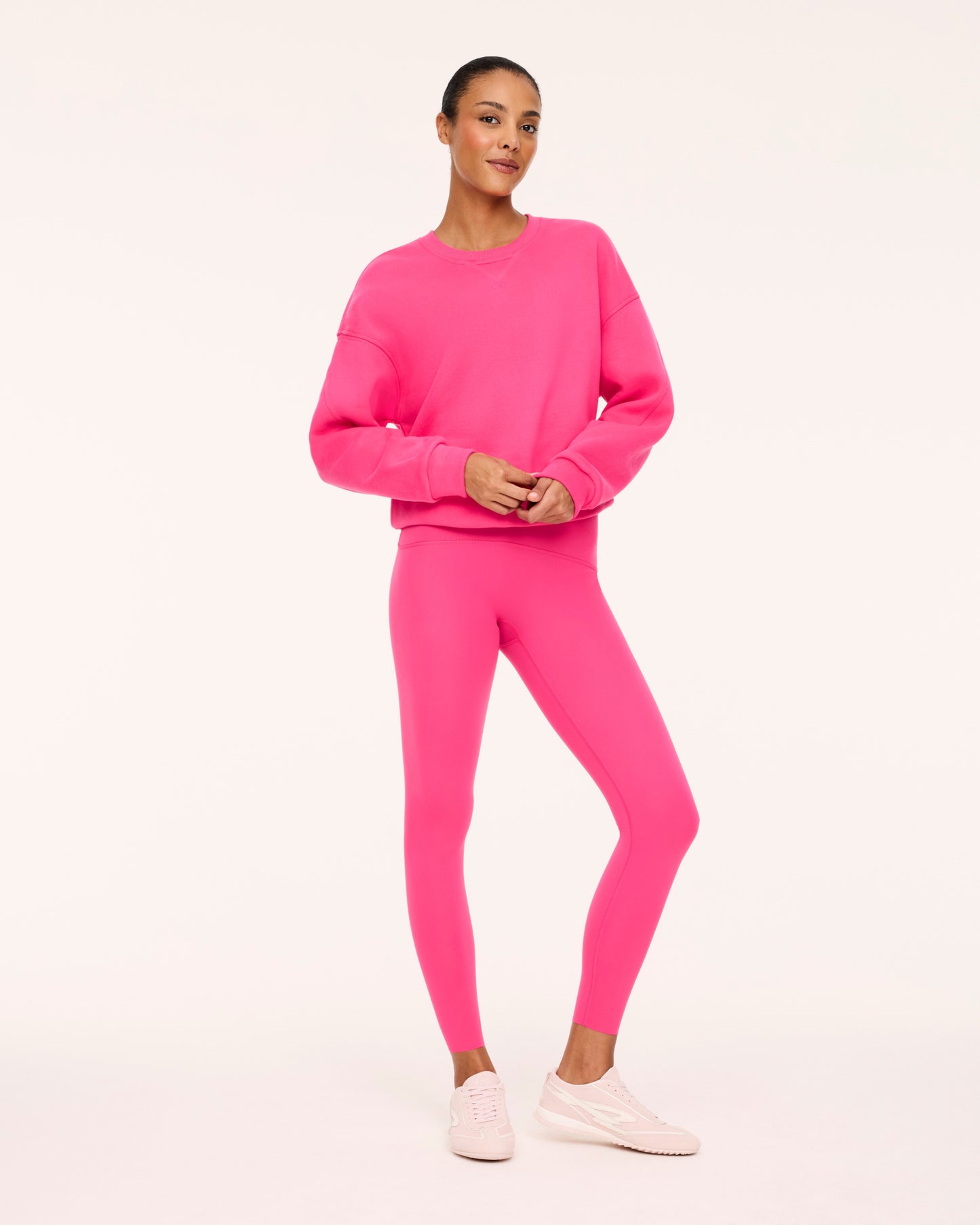 A woman wearing a matching Siren Pink Spanx set with white background from Britique Boutique in Bonaire, Georgia
