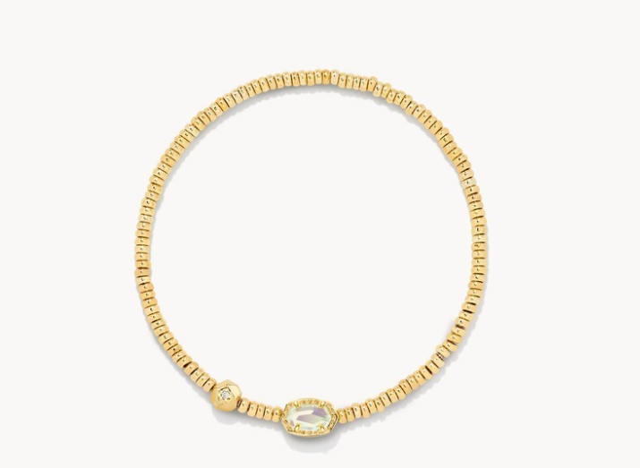 Gold bracelet with a clear gemstone on a white background